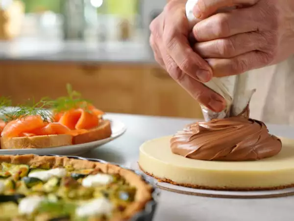 Menu del giorno, 9 luglio: un viaggio tra sapori con bignè al salmone, una torta salata con pesto, zucchine e mozzarella e un fresco dessert