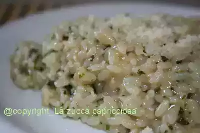 Risotto parmigiano con pesto basilico e piselli
