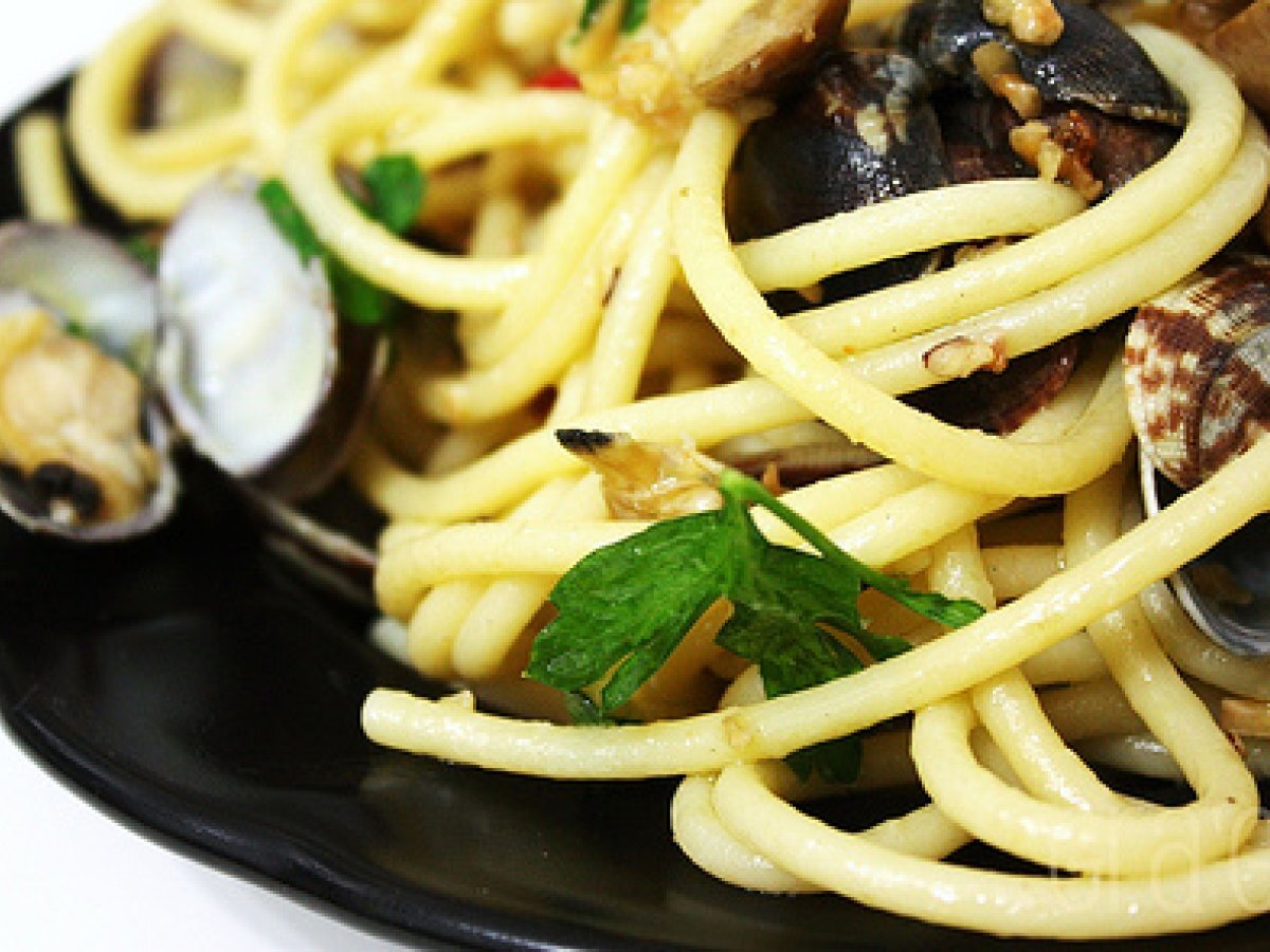 Spaghetti con vongole, nocciole e olive verdi